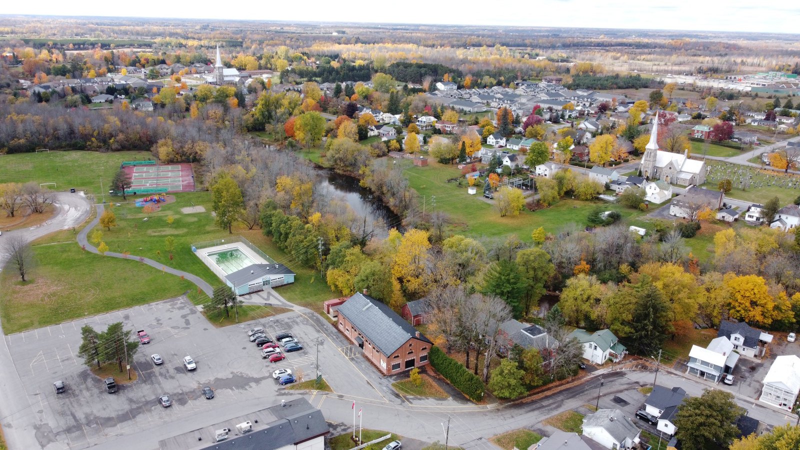 Riverside Park in Kemptville with outdoor pool, tennis courts, and church spires