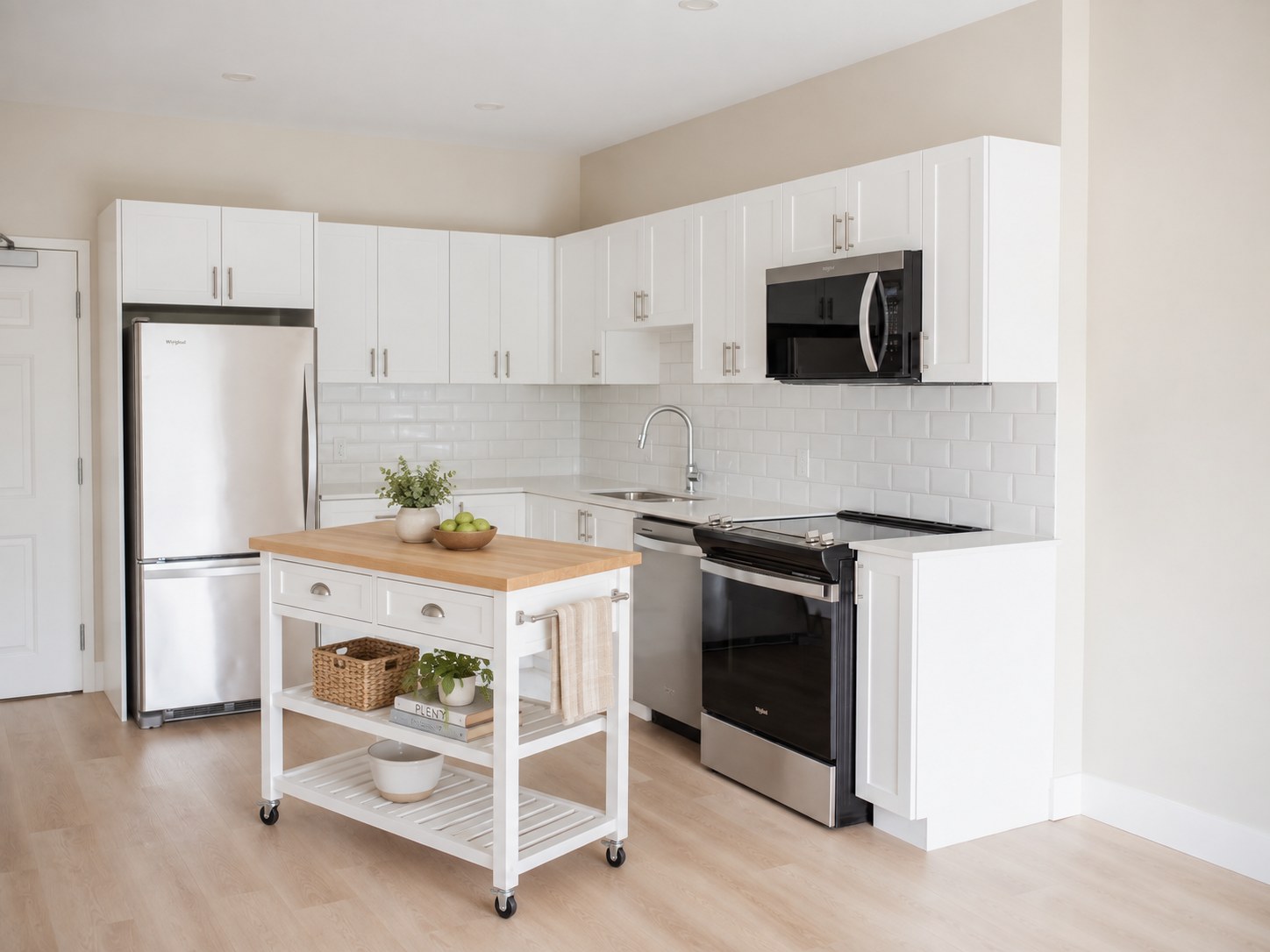 1 bedroom kitchen at Parkside Living with a rolling butcher-block island cart adding prep space and storage