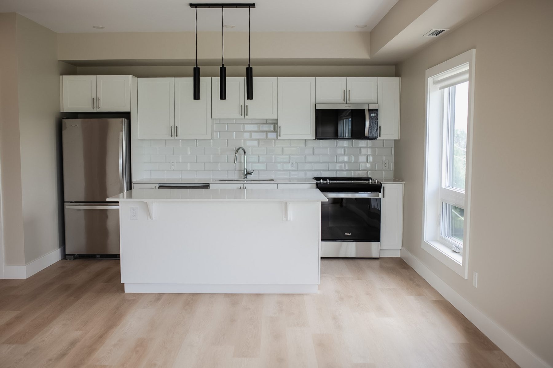 Kitchen with island in a 2 bedroom suite at Parkside Living